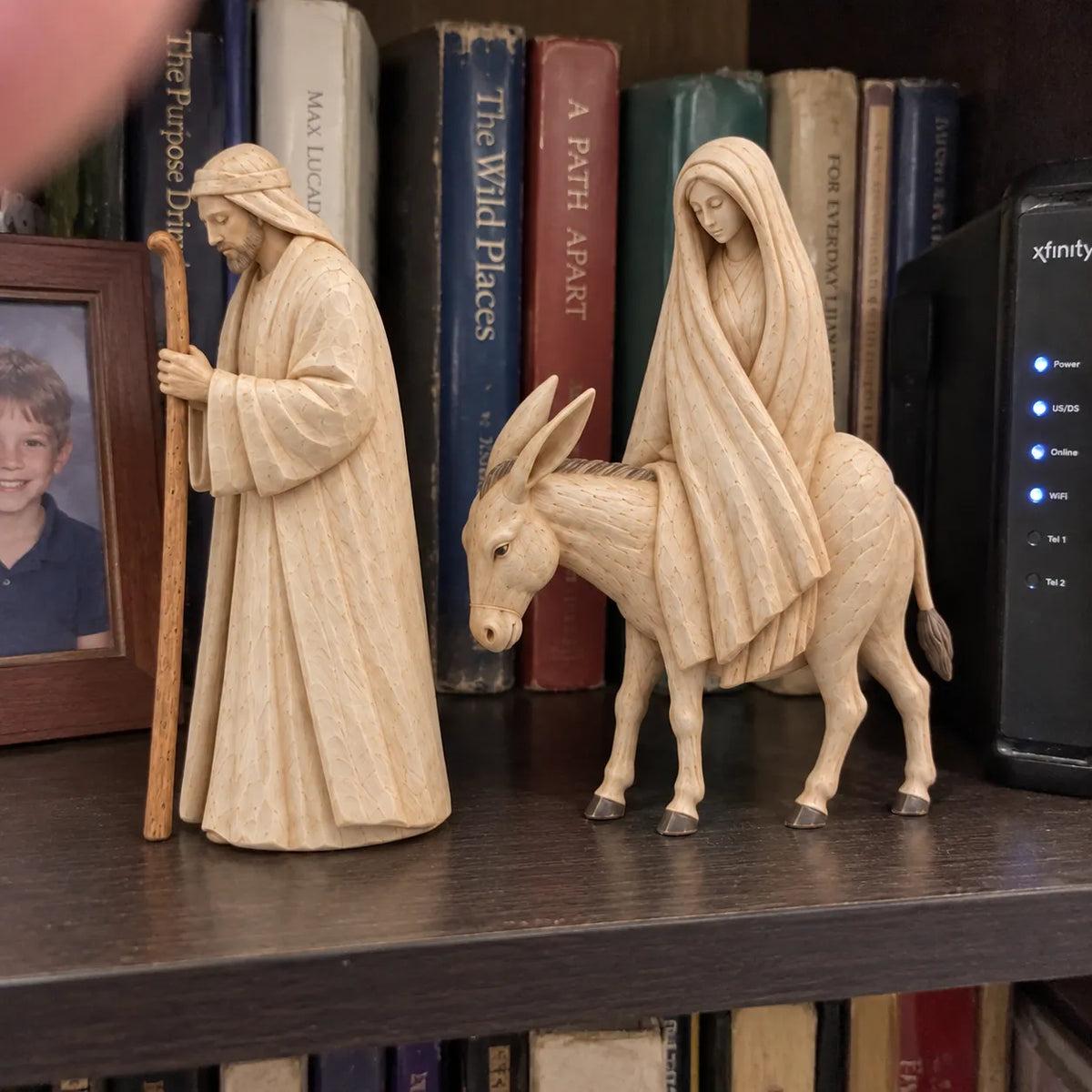 Mary and Joseph figurines displayed on a home bookshelf