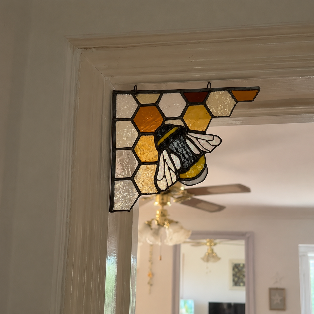 Honeybee stained glass decoration installed in a doorway corner