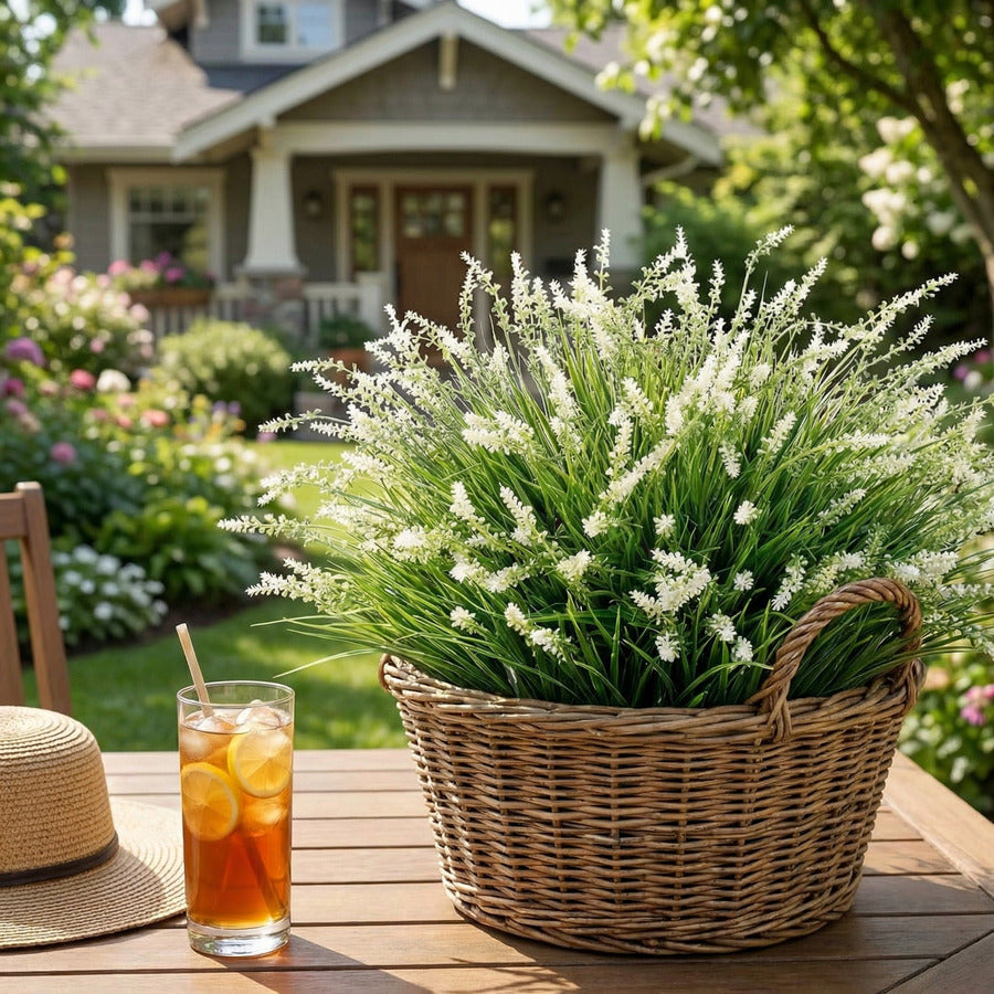 White faux monkey grass styled in a basket on an outdoor table