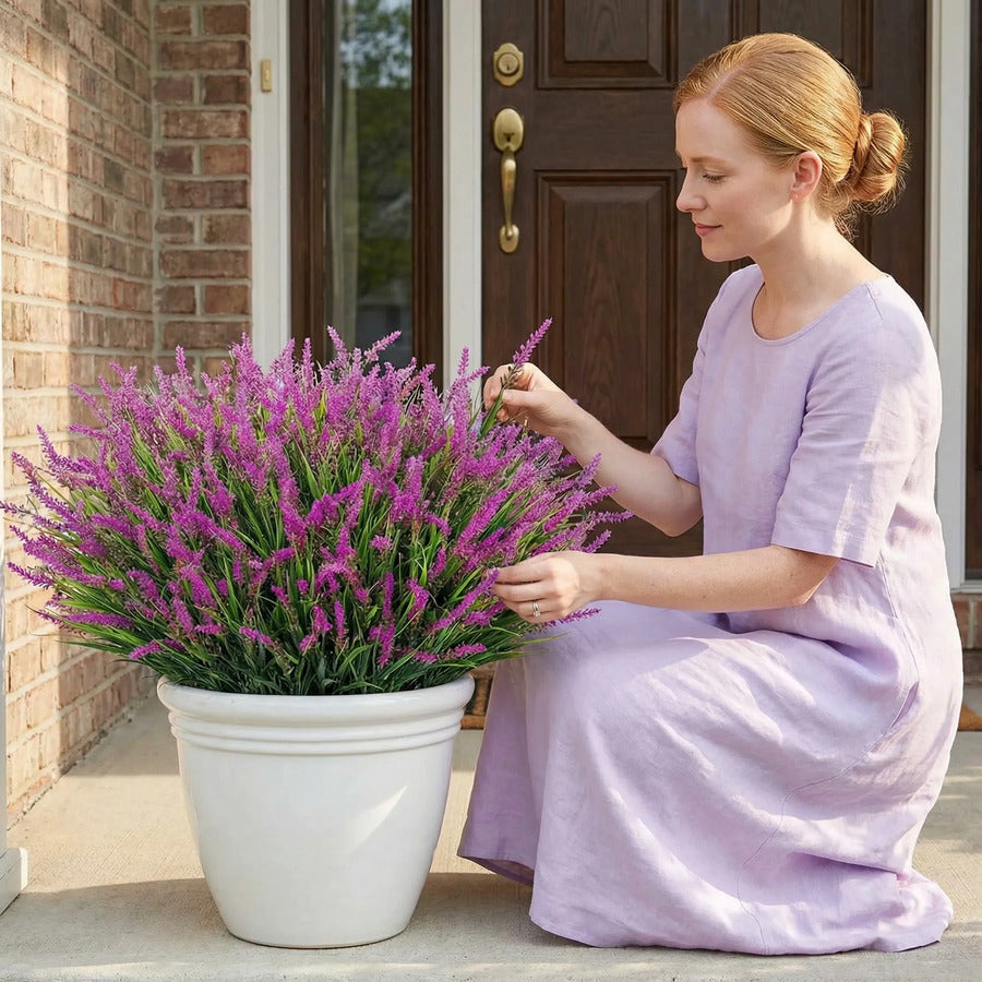 Woman shaping purple faux monkey grass in a porch planter