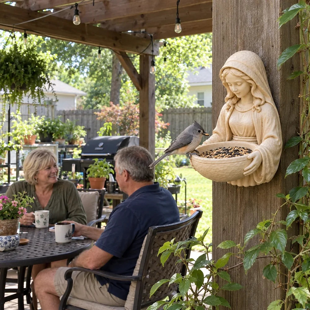 Bird feeder on a pergola post with a couple enjoying coffee in their backyard